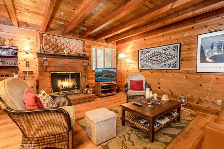 Main level living room with wood burning fireplace.