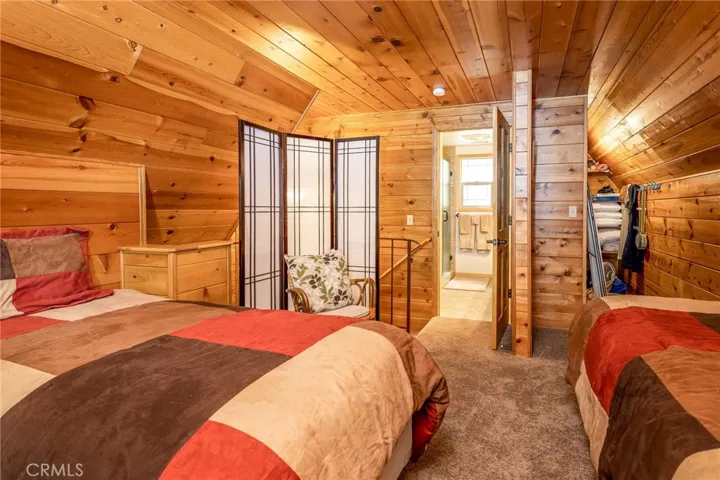 Loft bedroom with door to the bathroom.
