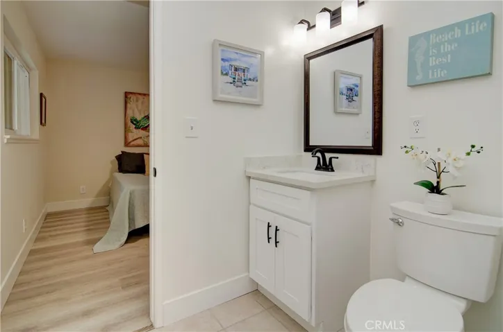 Roomy master bath has porcelain tile flooring, new vanity, quartz counter and bronze fixtures.