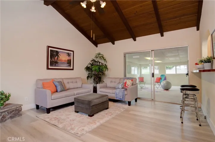 Separate family room has beautiful open beam ceiling and bar that opens to kitchen...perfect for homework or hanging out with the cook...