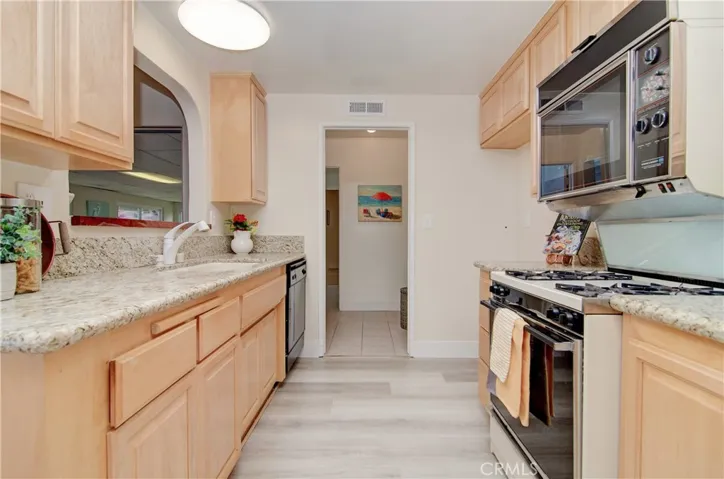 Remodeled kitchen has wood cabinetry and granite counters...also accesses inside laundry/utility room which offers more convenient storage.