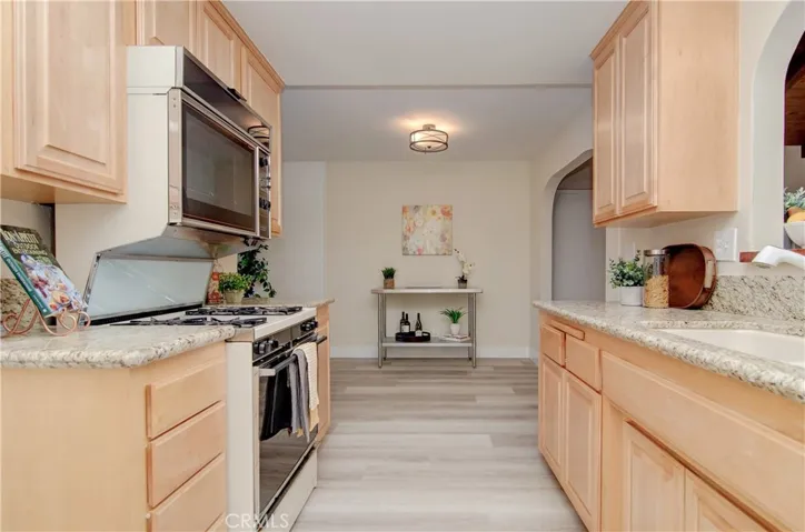 Step-saver kitchen is efficient for meal preparation and has breakfast bar to family room.
