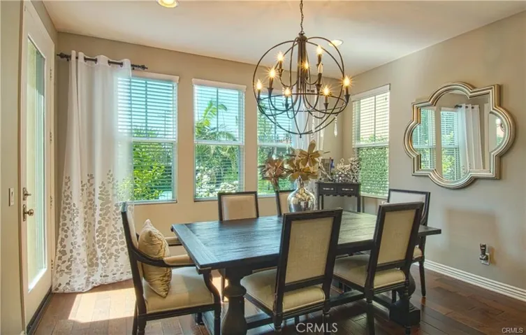 Formal dining area off great room with door leading to outdoor patio