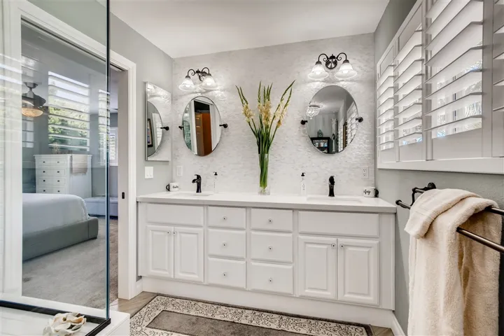 Master bath with a spa-like feel. It's stunning!                Counter tops are quartz. Mother of pearl back splash. Dual sinks. Gorgeous subway tile shower over tub with large shower box.