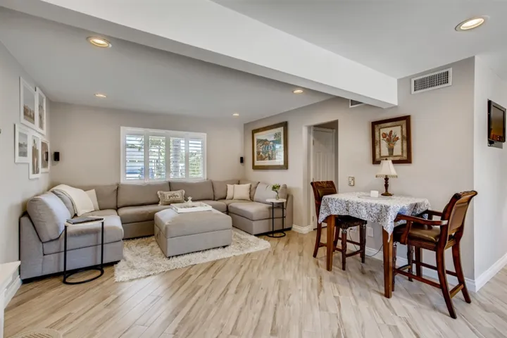 Recessed lighting, vinyl windows, white shutters and wood tile flooring.