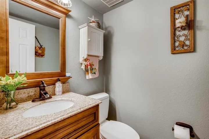Downstairs guest bath is well done. Granite counter tops and wood tile flooring.