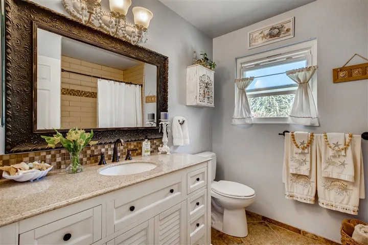 Upstairs full bath. Porcelain tile flooring, granite counter tops & subway tiled shower over tub. Very spacious!