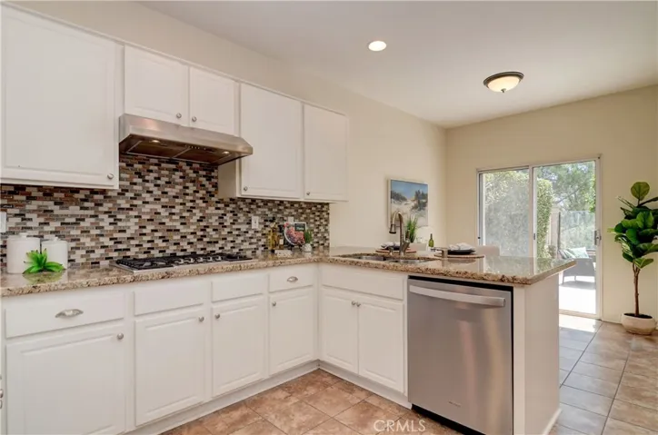 Any chef will love this kitchen with loads of fresh white cabinetry plus plenty of prep space...nice view to outside as well.