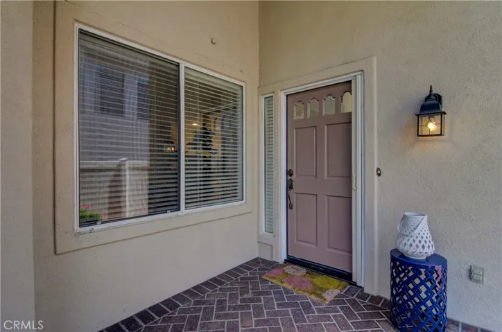 Covered front porch has nice brick accents and is a great place to greet friends and family.