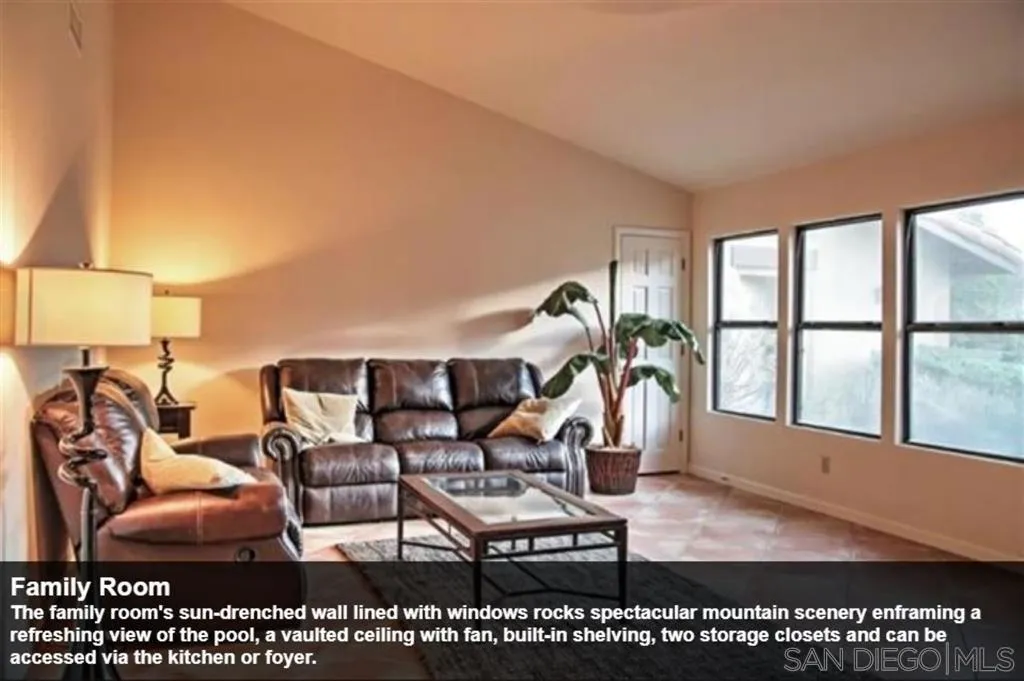 The family room's sun-drenched wall lined with windows rocks spectacular mountain scenery enframing a refreshing view of the pool, a vaulted ceiling with fan, built-in shelving, two storage closets and can be accessed via the kitchen or foyer.