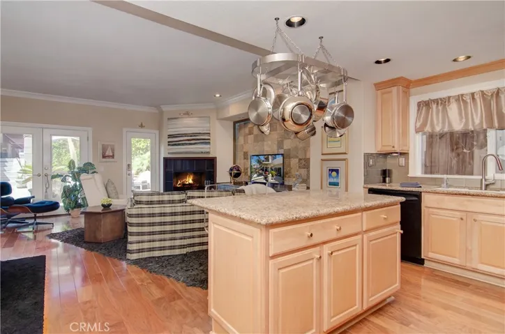 This family space has it all...island kitchen with plenty of prep and cabinet space, cozy fireplace, gorgeous hardwood floors and French doors to rear patio area.