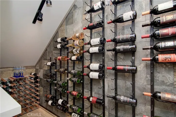 Custom wine cellar has plenty of room for any collection and the beautiful slate wall is a perfect display backdrop.