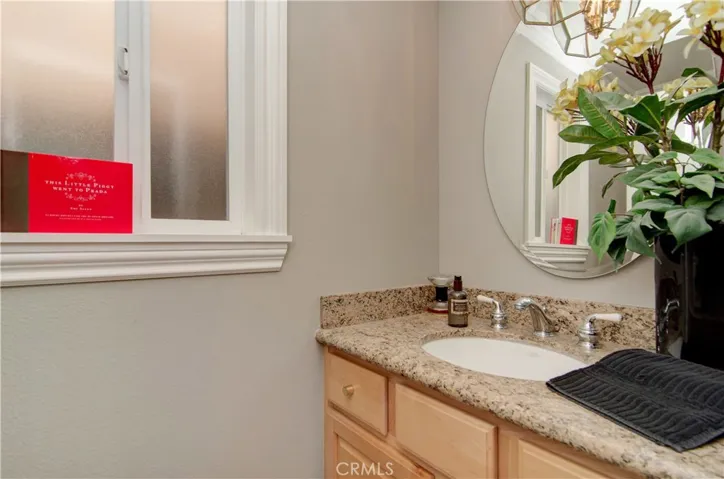 Main level bath has nice vanity area with stone counter and contemporary details.