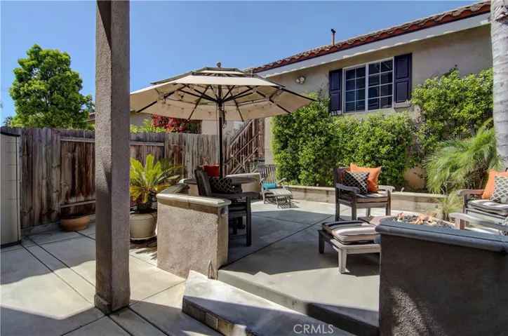 Rear patio is very private and has multiple "rooms" to enjoy...including BBQ area and raised loung space.