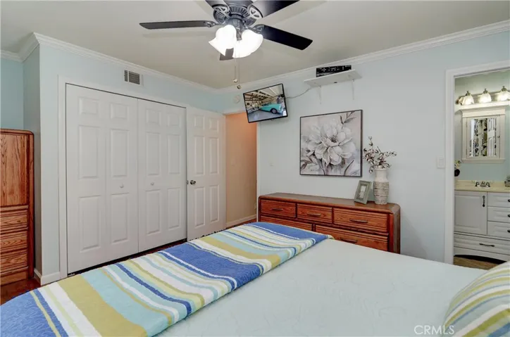 Master suite has large wardrobe closet, crown molding and those beautiful hardwood floors.