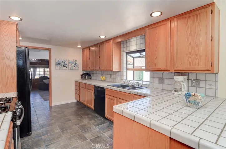 Gleaming kitchen has loads of cabinet and prep space...and every cook loves a window at the sink!