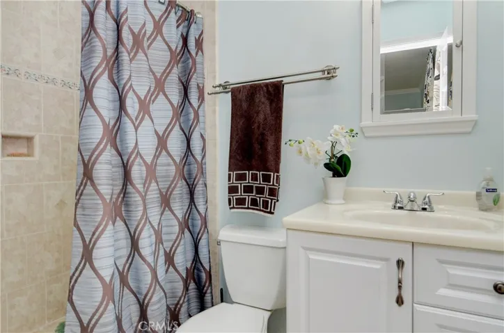Master bath has oversize tile shower and designer accents.