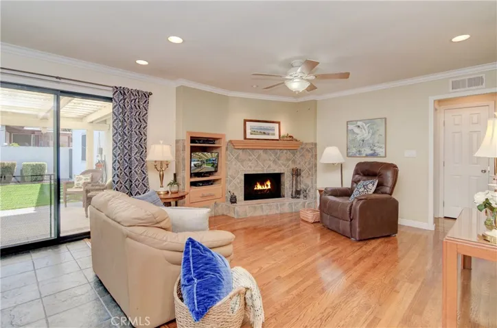 Living room has cozy fireplace and slider to rear yard. Most living areas have re-finished, orignal hardwood floors.