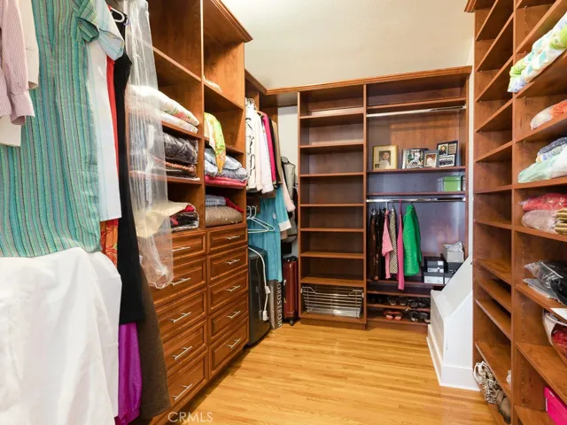 spacious walk in closet in master with laundry shoot