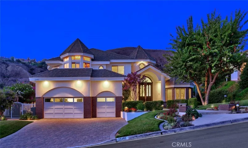 Stunning by day and by night, this Tudor style home is accented with 3 turrets, including the bay window at the front.