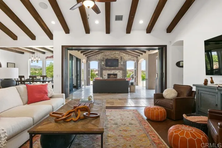Great room with Cantina doors that open up to Californi a Loggia room living- Custom Single Level home in Del Sur.
