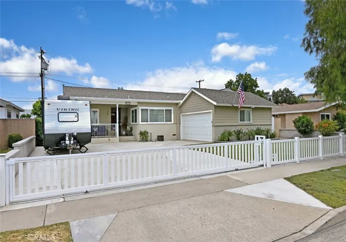 Picture perfect with an oversized gated drive and beautifully landscaped and lighted front yard