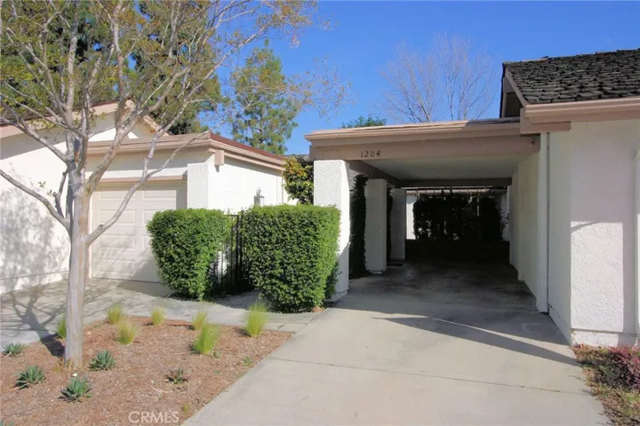 Welcome Home! 1 car attached garage and 1 covered carport lead you to the gated courtyard.