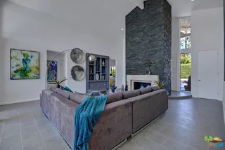 Living room with stacked stone fireplace