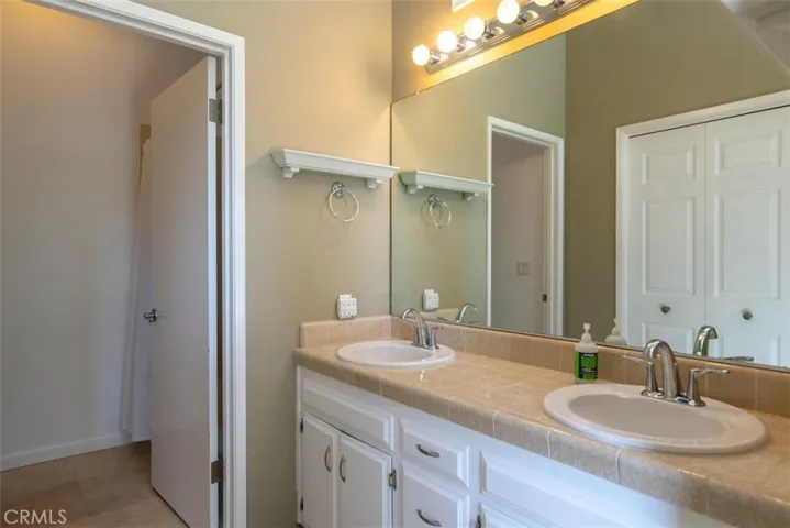 His and her sinks separate from the full bathtub/shower behind the privacy door.