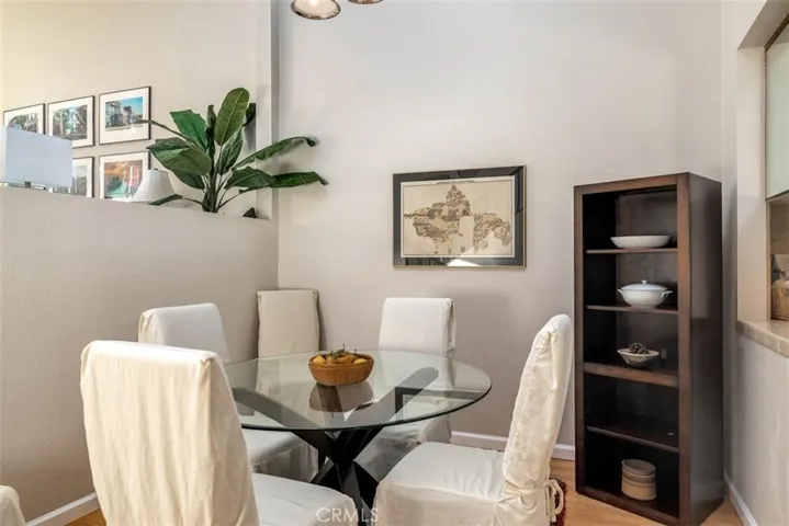 Dining area with an open window to the kitchen pass through counter.