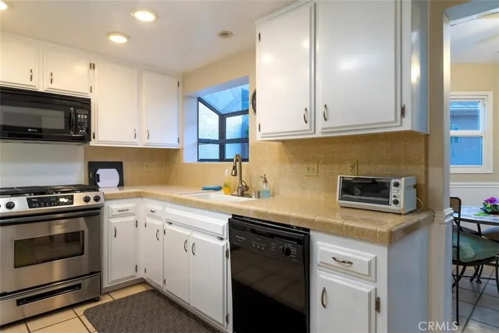 The kitchen with a peek into the sun room.