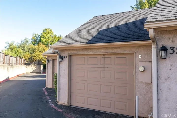Garage with extra storage and cabinets.