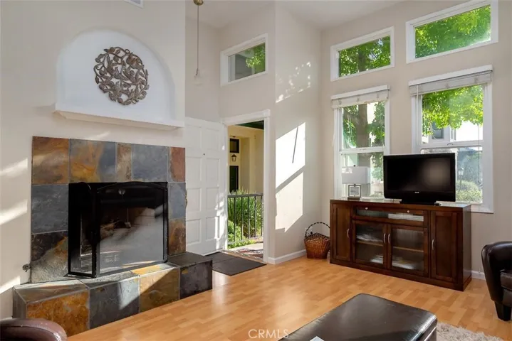 The front door opens into the beautiful living room with plenty of light and a fireplace for the evening.