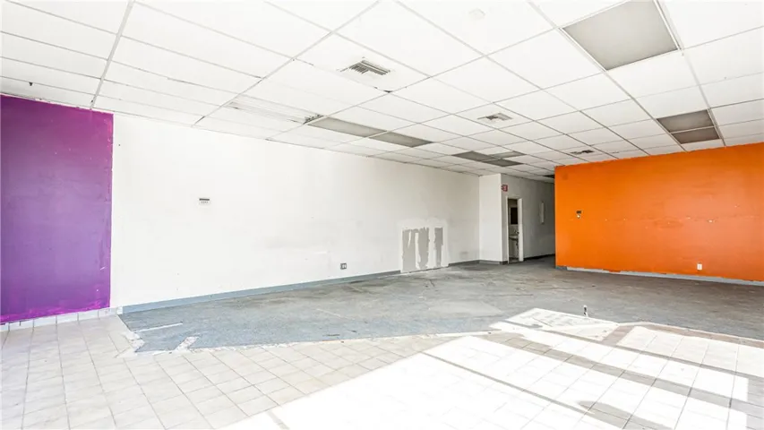 Taken from inside entry door towards rear office and bathroom.
