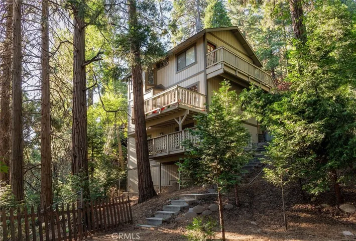 This is actually the view while standing in the backyard.  Top deck is from the master bedroom, middle deck off the dining room, main level. Bottom deck from the bottom living room area
