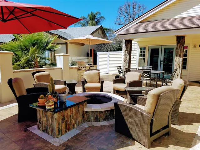 Talk about entertaining!  Amazing firepit/conversation lounge with built-in BBQ and custom tile.  Privacy wall with colorized glass.