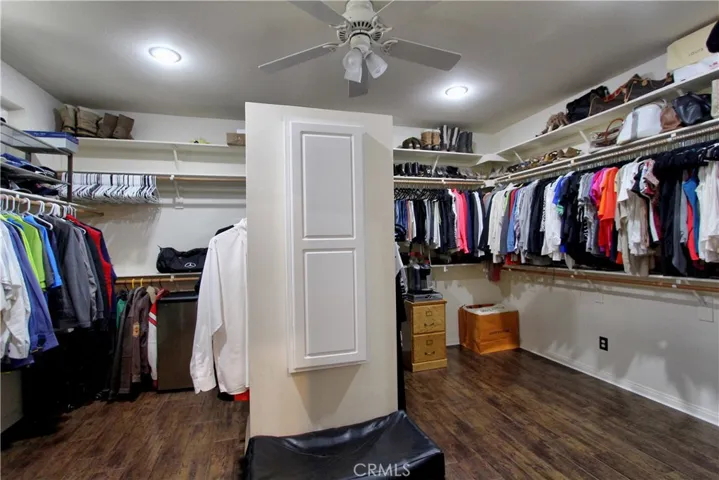 Over-sized master walk in closet with a built in ironing board.  Picture #1.  Notice the ceiling fan?