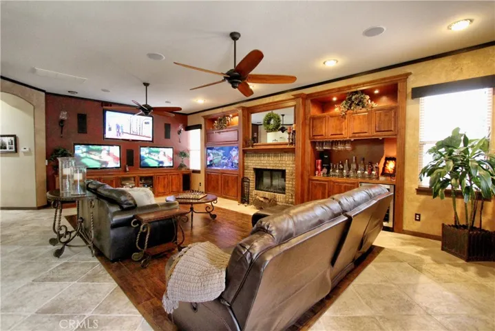 Family room off the kitchen with 3 built in TV's, built in 9 speaker surround sound system along with a 225 salt or fresh water fish tank built flush with the wall.