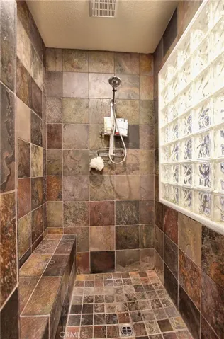 Walk in Master shower with sitting area.