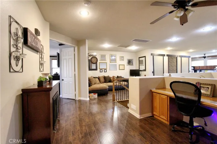 Landing at the top of the stairs.  Looking at the large master suite through the double door entry on the left.  Separate sitting are to the right as it leads down the hallway towards the loft area.