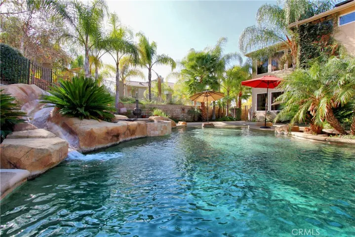 Beautiful relaxing custom Pebble Tec beach entry pool with a water slide.  Offers an extra large spa with a waterfall.  Pool can be heated and fully controlled from an app on your phone.