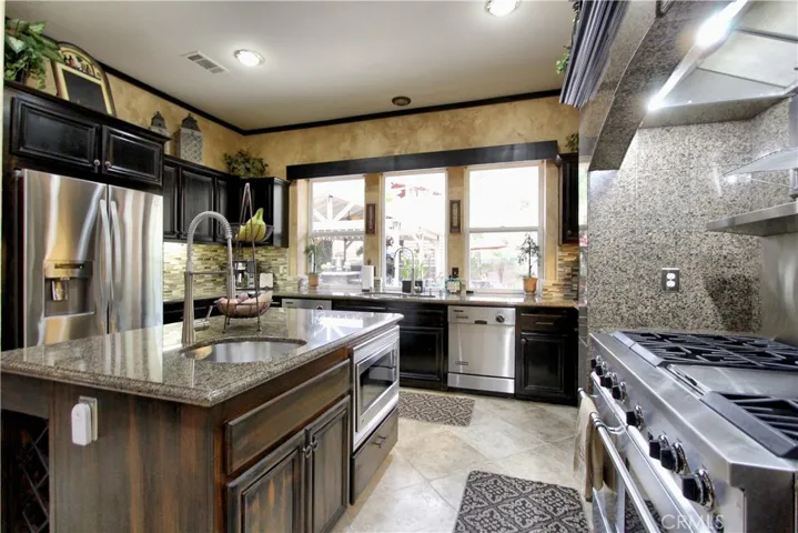 Gourmet kitchen with Island.  The Island offers a sink, garbage disposal, trash compactor and a microwave.