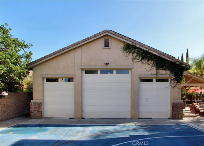 Separate RV garage that can hold up to 9 cars.  Approximately 830 sq ft. and 35'3" wide and 35'4" deep.  The two outer doors are 10' high and the middle one is 12'. Has 220.  Large dog run on the side and separate fenced area for firewood.