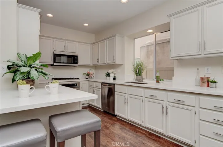 Bright, updated kitchen has LOADS of cabinet and counter space.