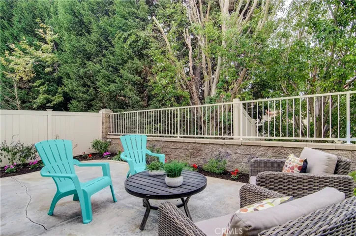 Living is EZ in this private rear yard with low, low maintenance...someone else has to trim the trees!