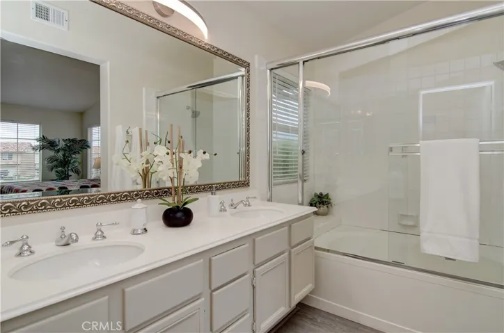 Sparkling master bath has dual sink vanity and large soaking tub.