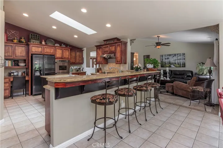 Open and spacious kitchen, breakfast bar, double ovens, office area, skylight and more!