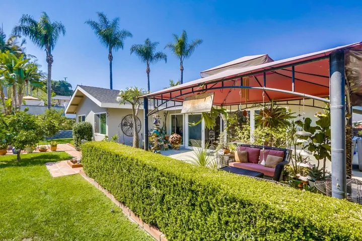 rear yard showing grass area behind hedge that separates the yard