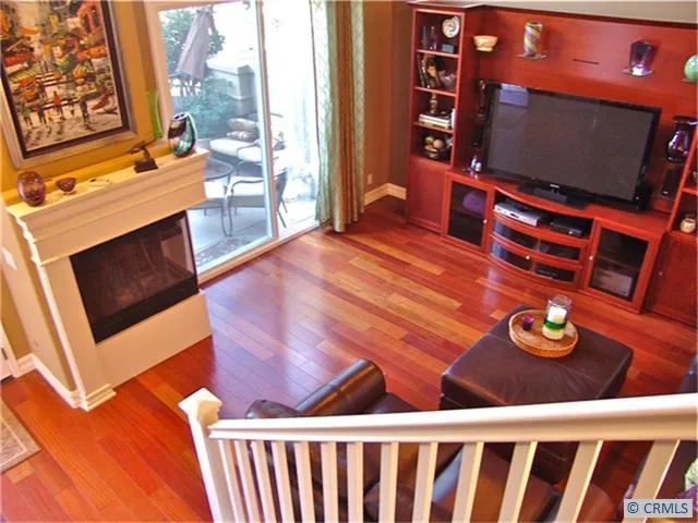 View of living room and front terrace...gorgeous hardwood cherry floors abound & note the first of two fireplaces!
