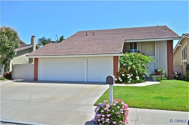 Lovely curb appeal with sweeping lawn and lush landscape